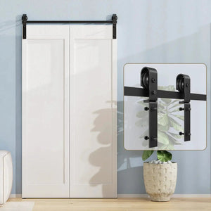 Bi-Folding Sliding Barn Door Hardware Track Kit in black metal with dual-roller carriages mounted above white double doors