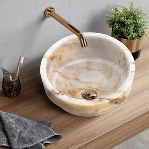 Bianco Giallo marble vessel sink bowl with gold wall-mounted faucet, white with yellow veining.