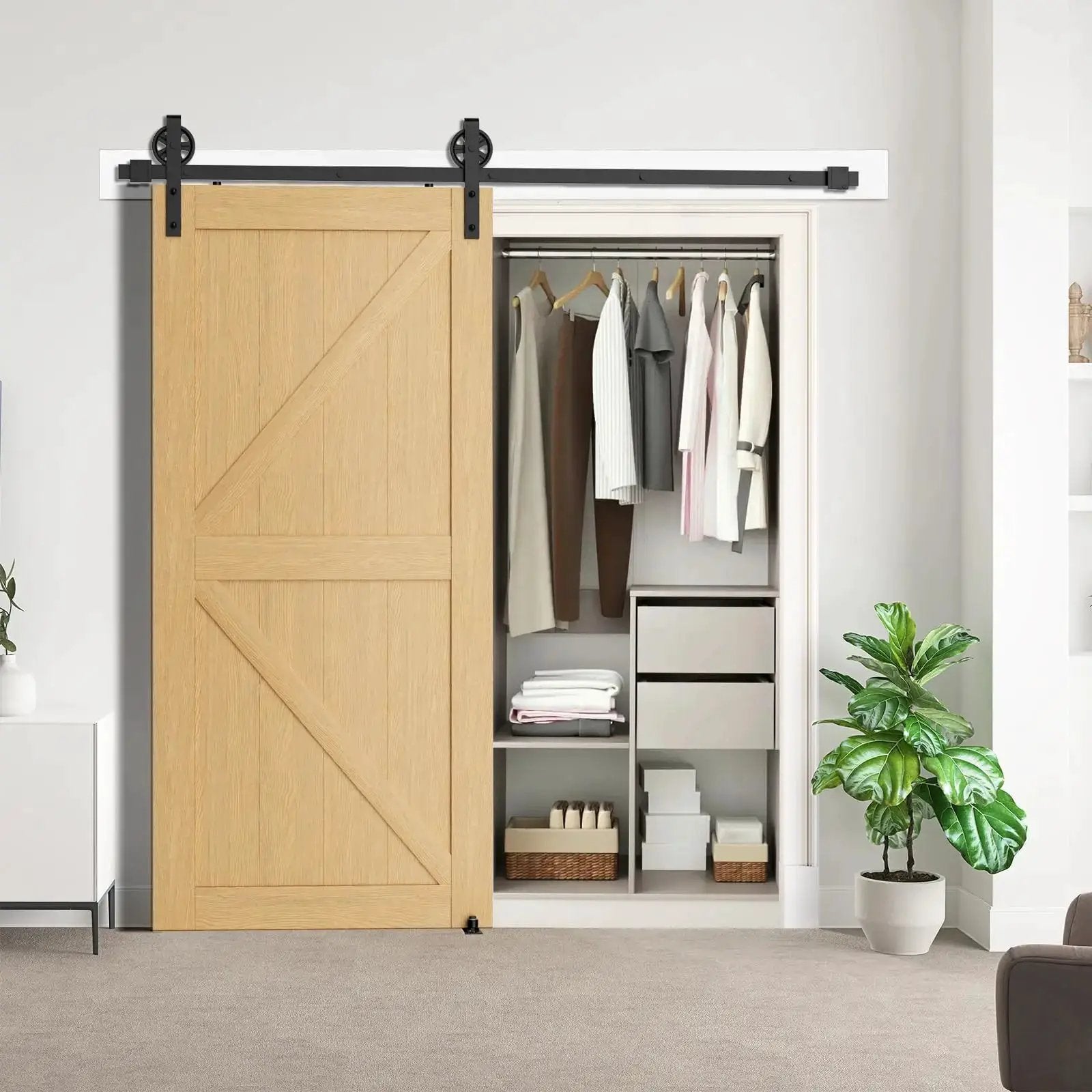 HAUSVITA sliding barn door hardware kit in black with big-spoke rollers on track over a wooden sliding door