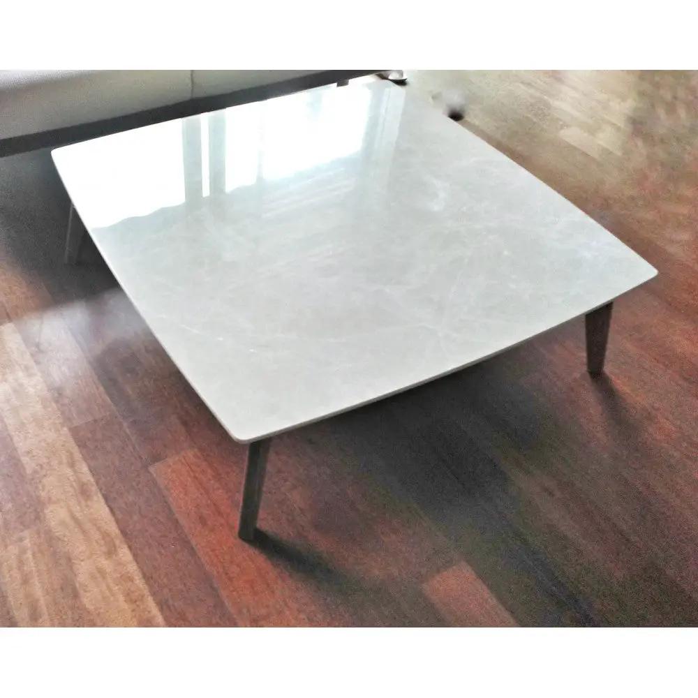 Burdur beige marble coffee table, rectangular with polished top and eased edges, dark tapered legs.
