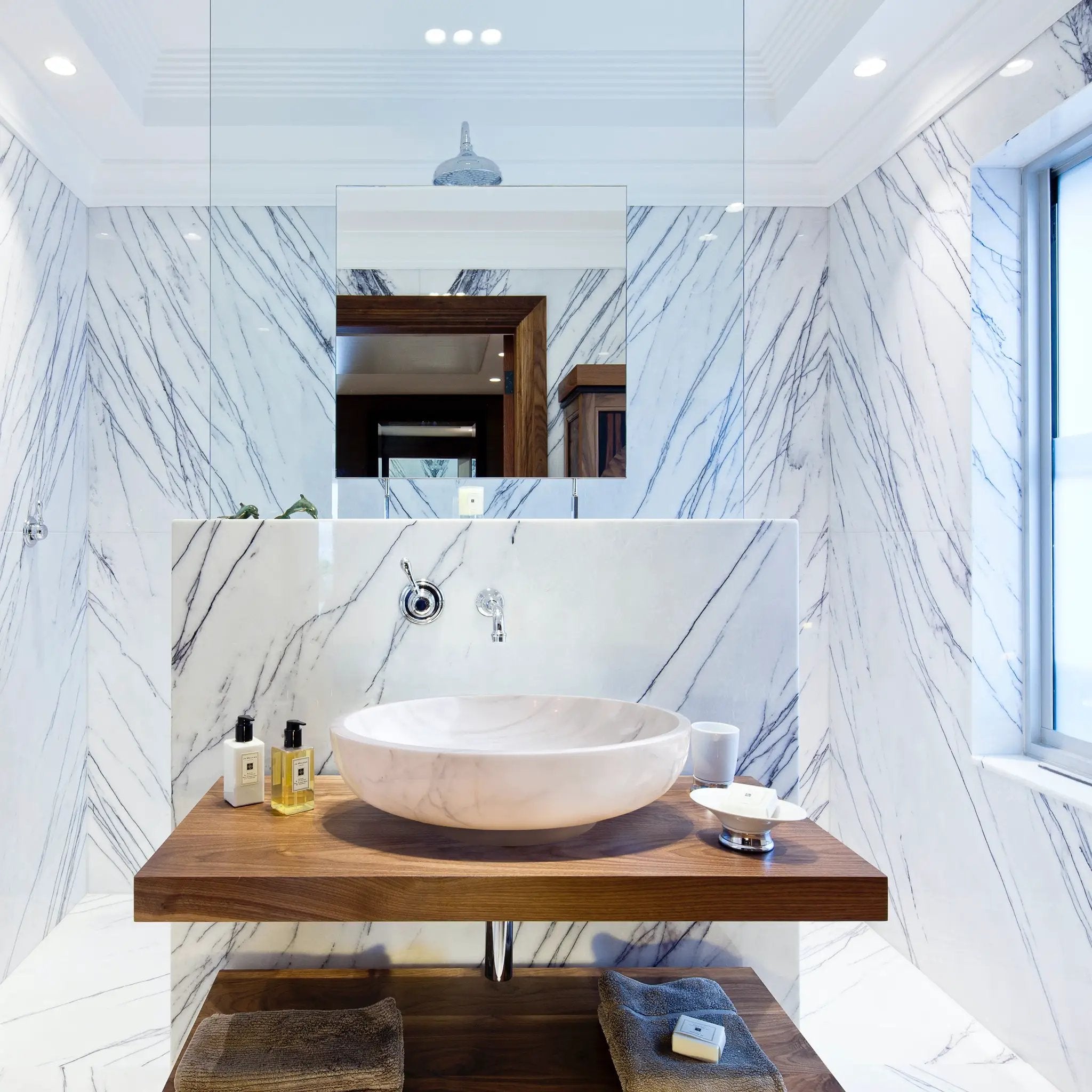 Calacatta white marble vessel bathroom sink by Villohome on a wooden vanity