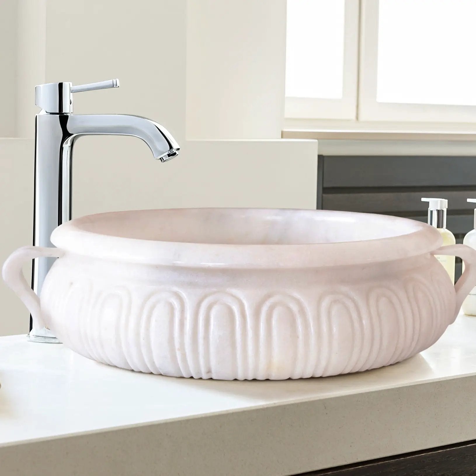 Calacatta white marble vessel sink with chrome faucet on bathroom vanity