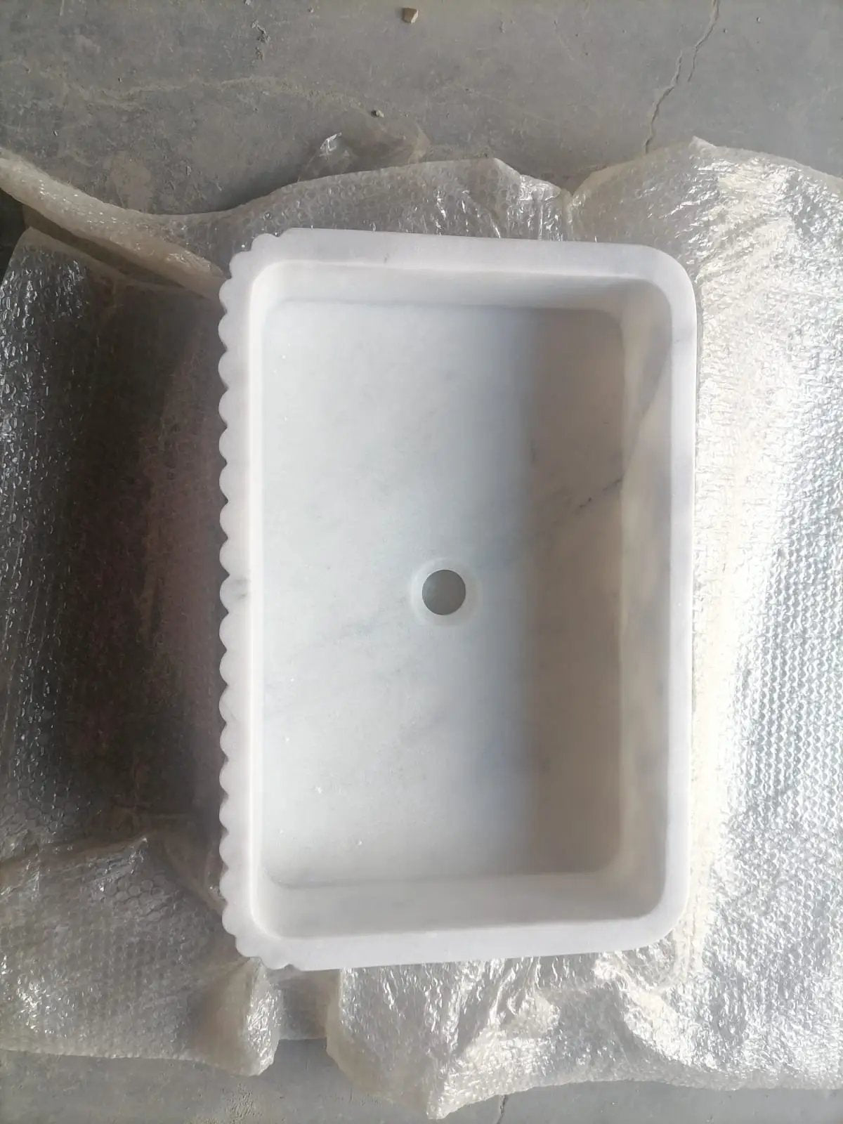 Carrara white marble wall-mount bathroom sink by Villohome with ribbed scalloped edge