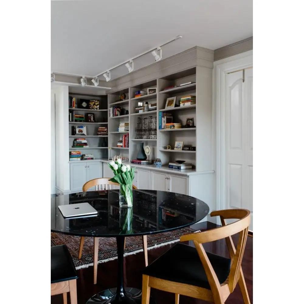 Round black marble dining table with polished, eased edge by Villohome