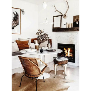 Round marble dining table with polished and eased edge in a white living room