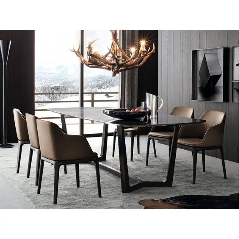 Marble dining table, rectangular with a polished, eased edge and dark top, paired with brown upholstered chairs.