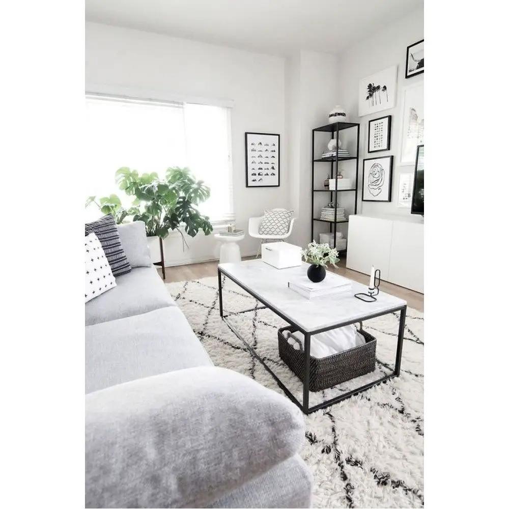 Marble coffee table, rectangular with a polished top and eased edges, black metal frame.