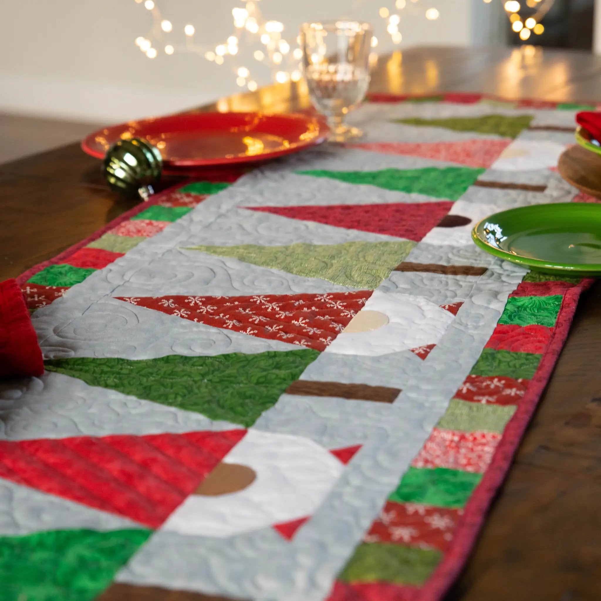 Christmas Gnomes Quilted Table Runner Precut Quilt Kit by Block Party Quilt Co, festive red and green patchwork fabric.