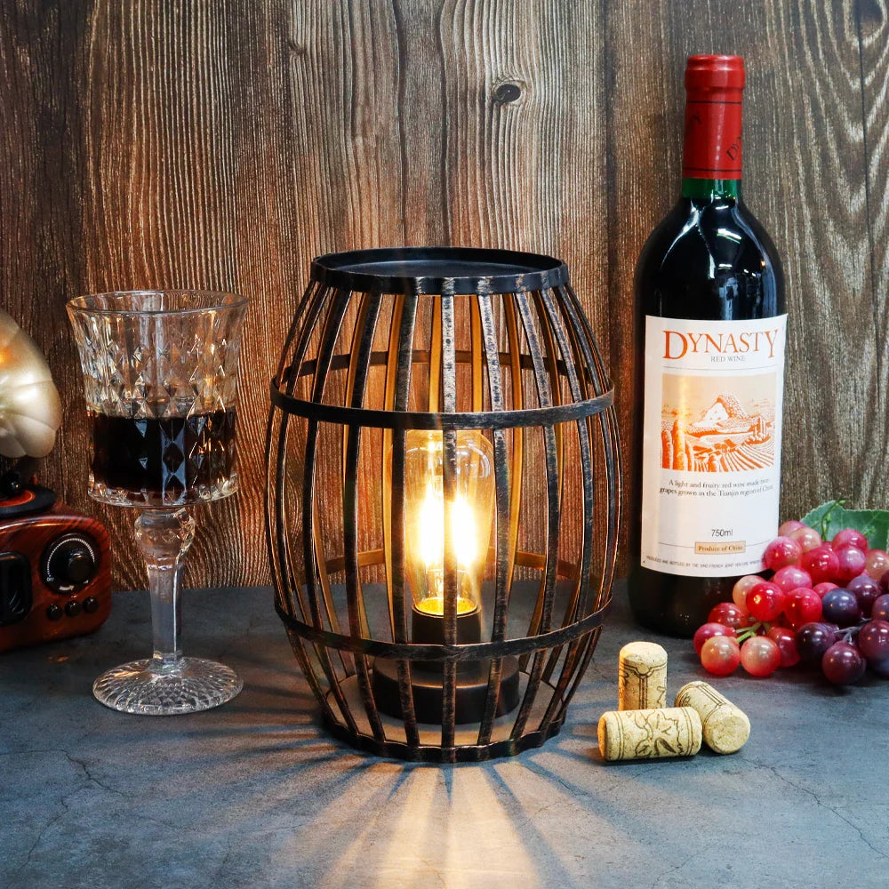 Cordless metal wine-barrel lamp, 8"H, black brushed-gold finish with warm glow, battery operated.