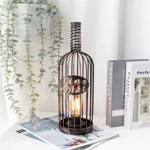 Cordless metal wine cork lamp in bronze cage with warm Edison bulb.