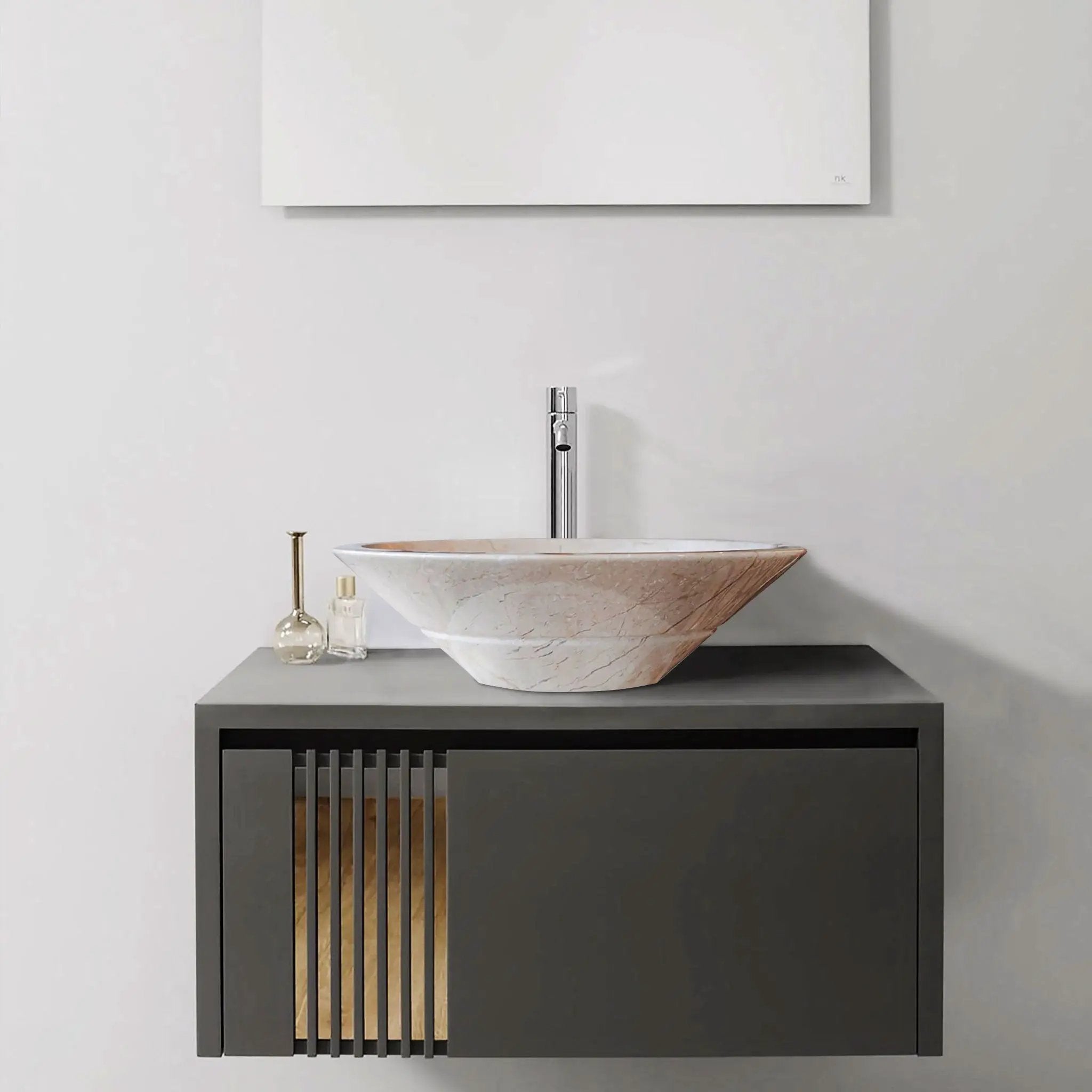 Crema Marfil marble vessel sink atop a dark vanity with gold vertical slats