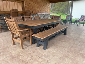 Harmony Outdoor Table with brown wood benches and chairs on a covered patio.