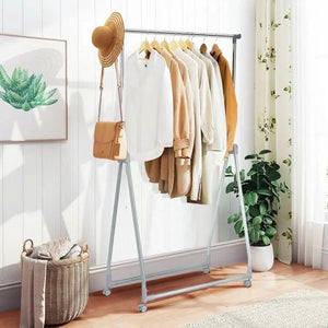 HomePacific folding extendable metal garment rack with lockable wheels, gray frame with clothing hung on rod in bedroom