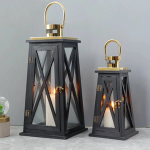 Set of 2 farmhouse wooden decorative candle lanterns, black trapezoid, 12in and 18in tall with gold metal trim.
