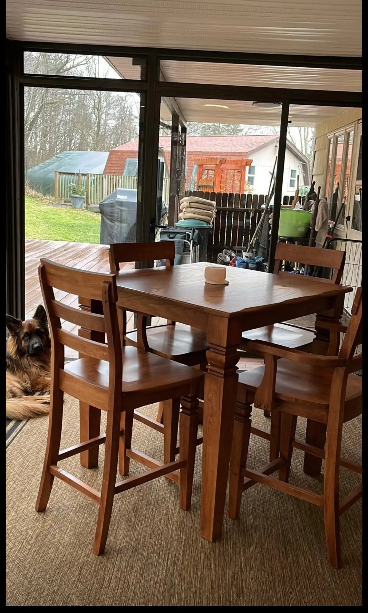Java stools, set of four, solid wood with warm brown finish around a wooden dining table