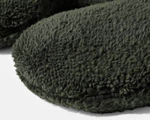 Weighted Neck Pillow by Gravity Blankets, dark green plush travel pillow.