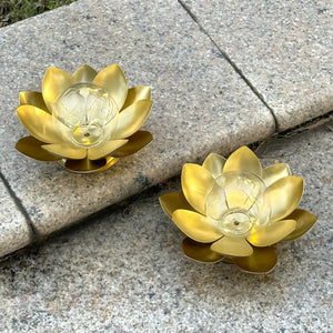 Set of 2 gold lotus battery-operated table lamps with warm lights on a granite surface