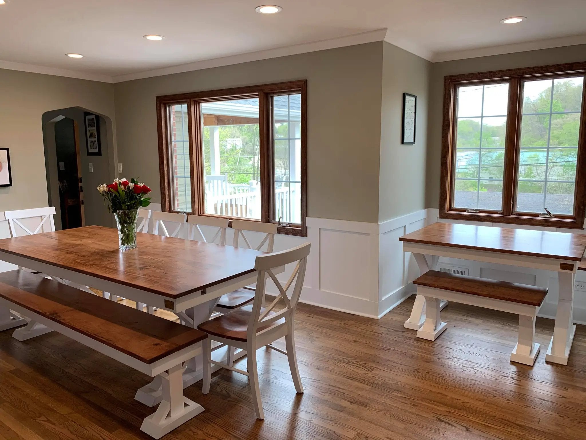 Single X Chairs set in white with wooden seats around a large wooden dining table and benches.