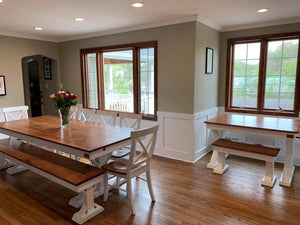 Single X Chairs set in white with wooden seats around a large wooden dining table and benches.