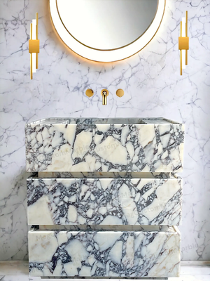 Freestanding vanity unit in Calacatta Viola marble with purple/gray veins and gold fixtures by MEG Custom Marble
