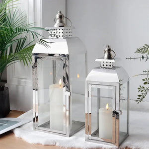 Decorative candle lanterns set of 2 by JHY DESIGN, stainless steel with glass panels, 20.5 in and 15 in tall.