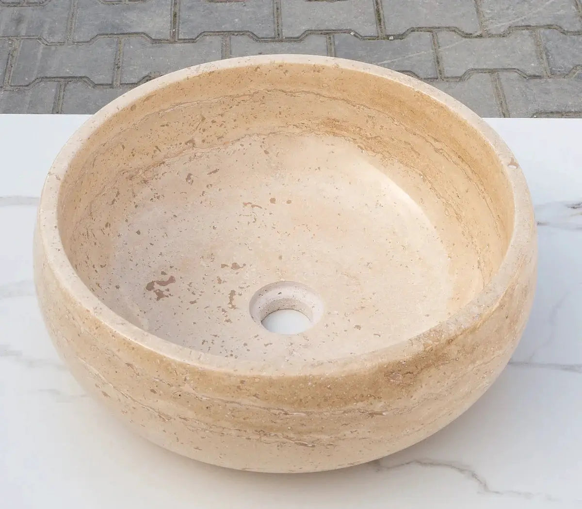 Travertine bathroom vessel sink, light beige round stone basin with polished interior and center drain
