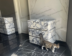 Calacatta Viola marble vanity blocks with purple-gray veins by MEG Custom Marble; cat nearby