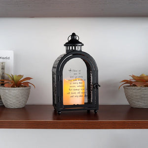 11-inch High Memorial Lantern in black, decorative candle lantern with a lit candle inside.