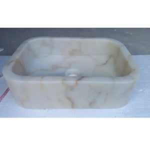 European sugar white marble bathroom sink, rectangular above-counter vanity, white with subtle brown veining.