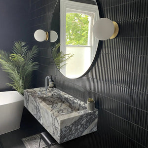 Calacatta Viola marble rectangular wall-mount bathroom sink with side faucet holes and gray veining.