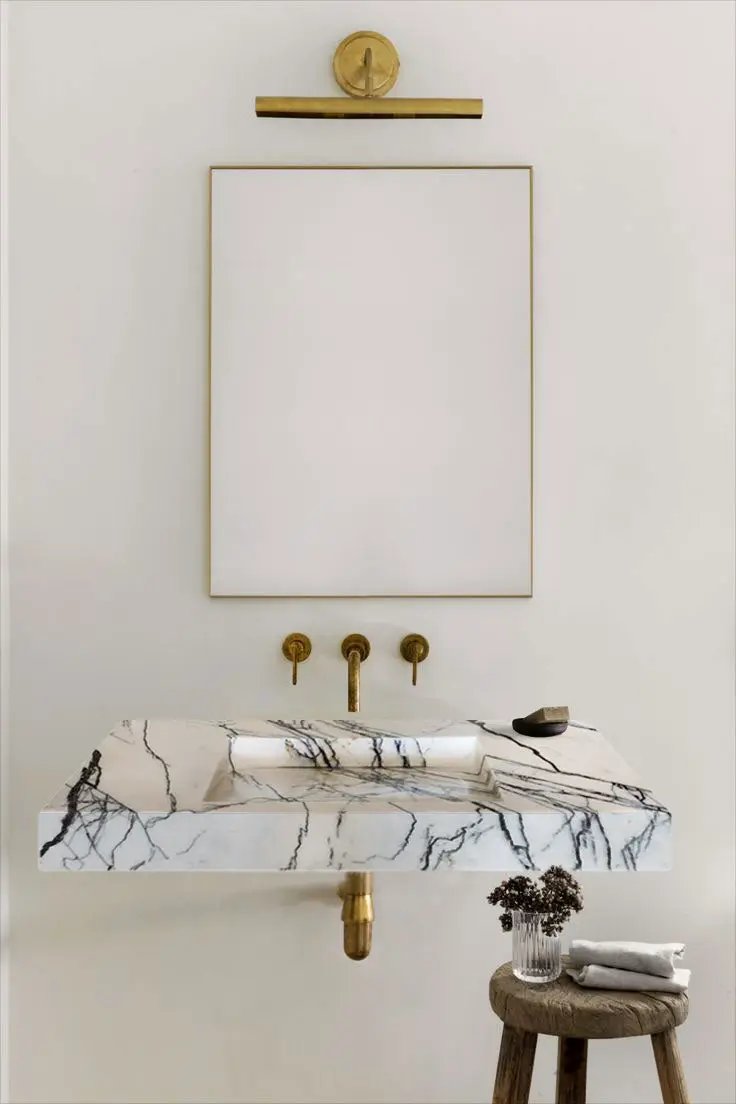 New York Marble wall-mount bathroom sink by Villohome; white marble with brass fixtures and hidden drain
