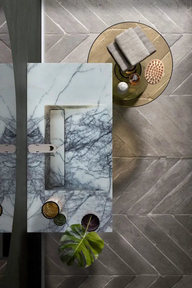 New York Marble wall-mount bathroom sink by Villohome with drain cap, white marble with gray veins.
