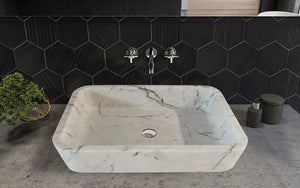 Carrara white marble rectangular wall-mount bathroom sink by Villohome; gray veining, black hex tile backdrop.