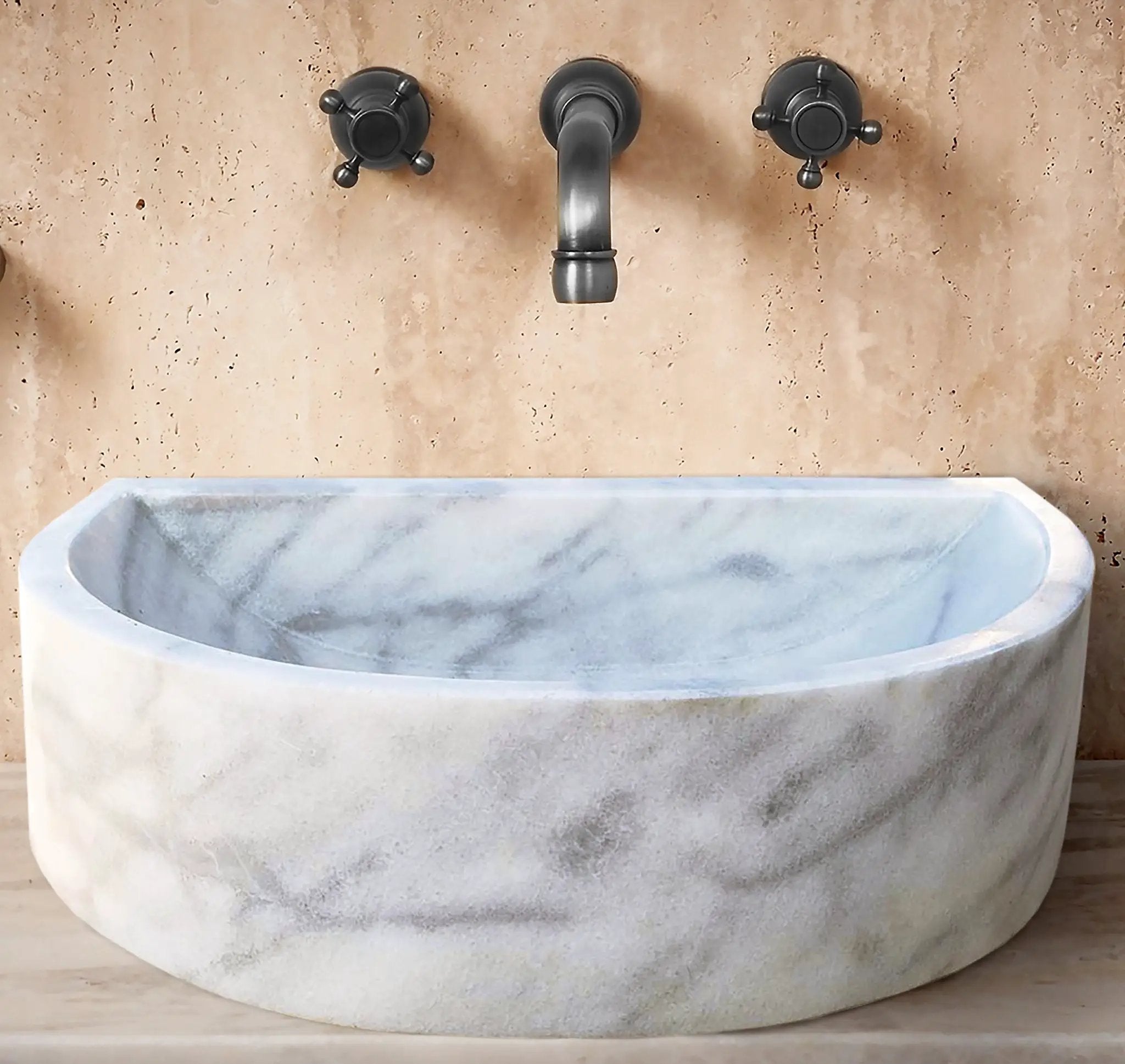 Carrara White marble wall-mount bathroom sink, 24W x 20D x 6H, with black faucet handles.