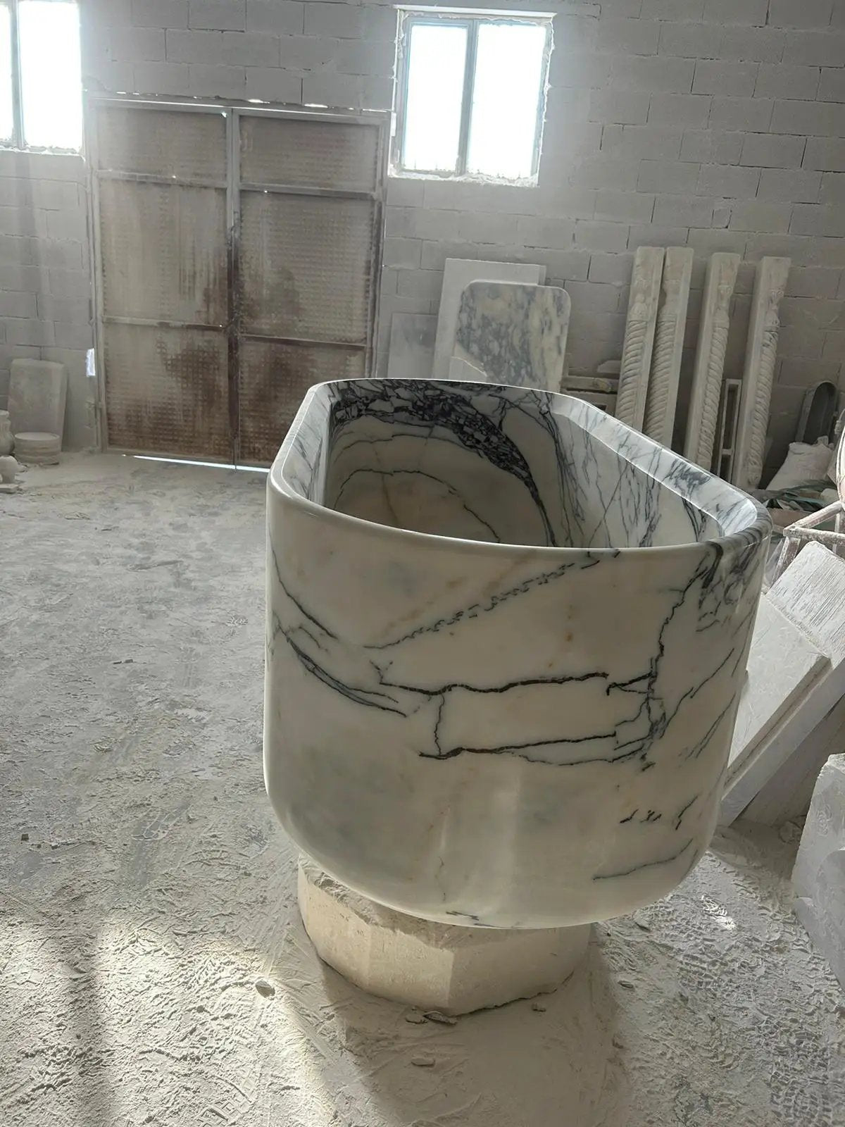 New York marble bathtub handcrafted from solid marble block; white with dark veining