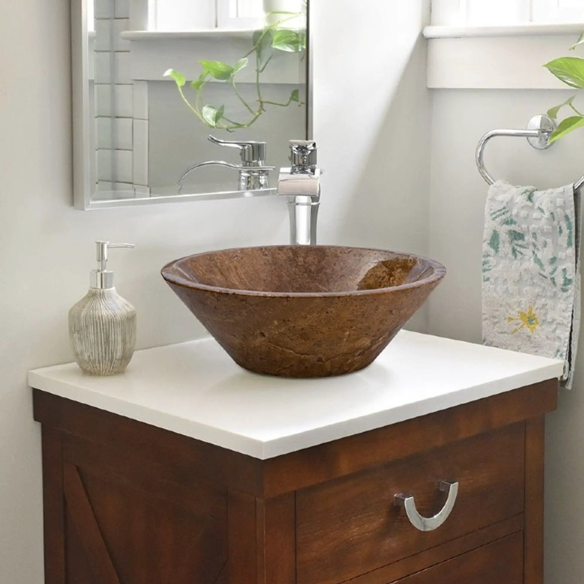 Noce brown travertine vessel sink atop a white vanity with chrome faucet in a modern bathroom.