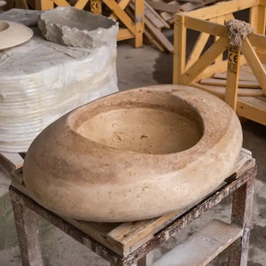 Noce Travertine round above-counter bathroom vessel sink in natural beige stone, Villohome kayak design.