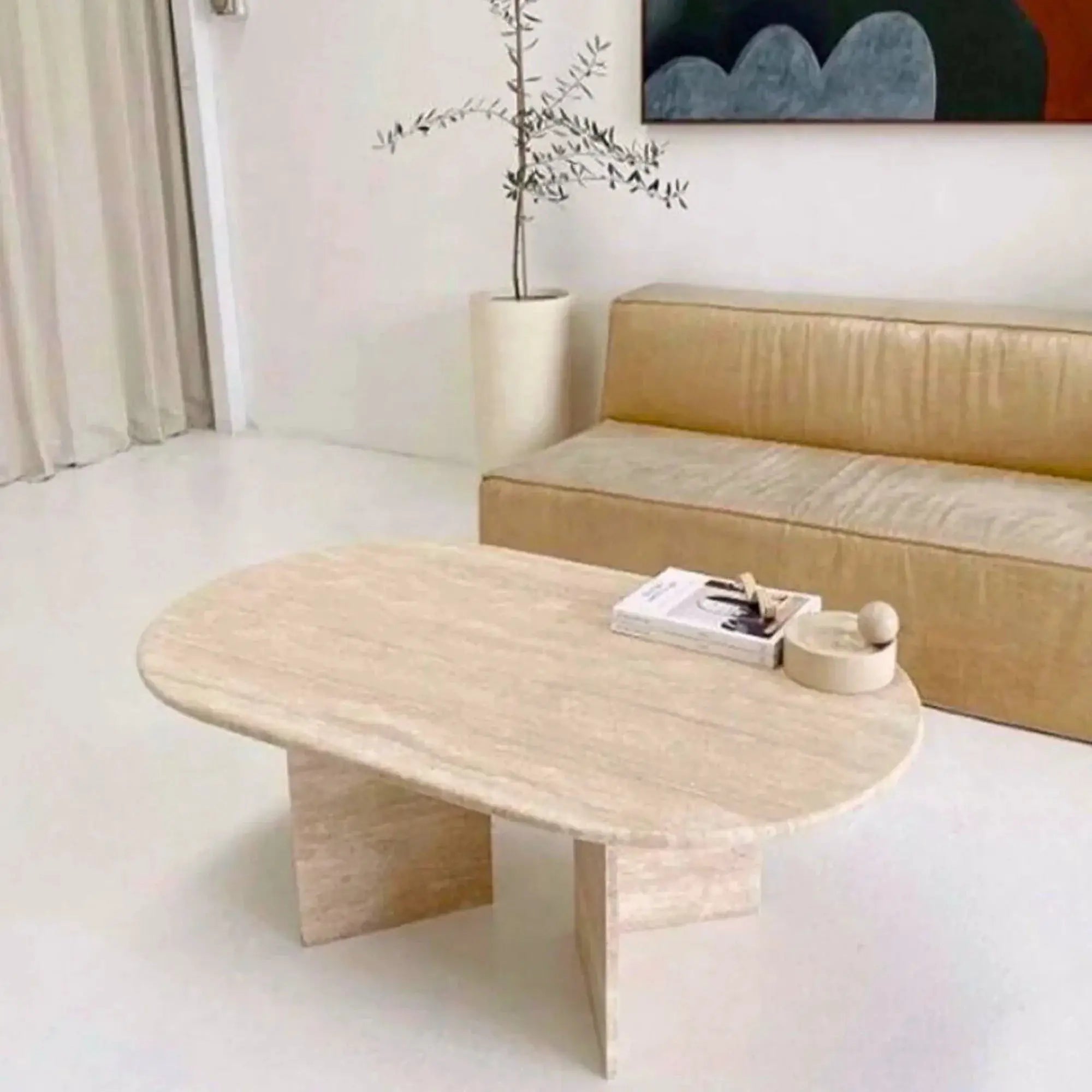 Troia Light Travertine oval coffee table by Villohome, filled and polished surface in a modern living room.