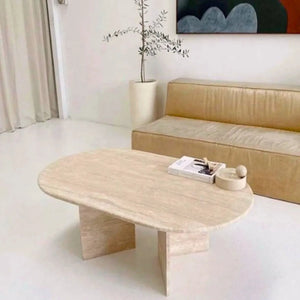 Troia Light Travertine oval coffee table by Villohome, filled and polished surface in a modern living room.