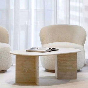 Villohome Troia Light Travertine oval coffee table with polished travertine pedestal bases.
