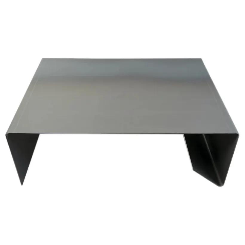 Rectangular metal coffee table in raw steel with folded-leg supports
