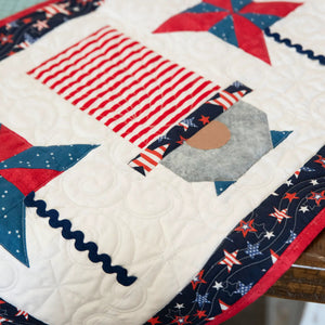 Quilt Kit: Patriotic Gnomes Table Runner precut by Block Party Quilt Co in red, white, blue fabrics.