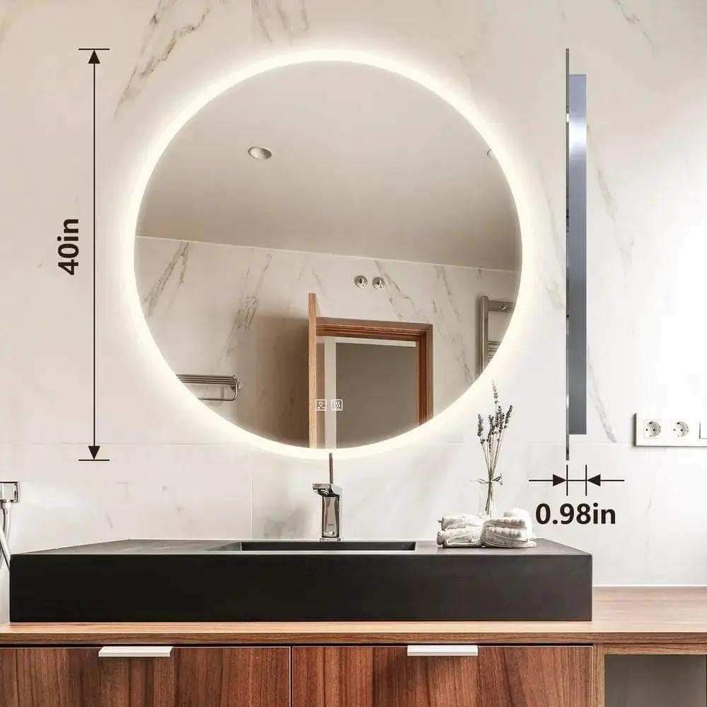 Round backlit LED bathroom vanity mirror with dimmable lighting mounted above a black countertop sink.