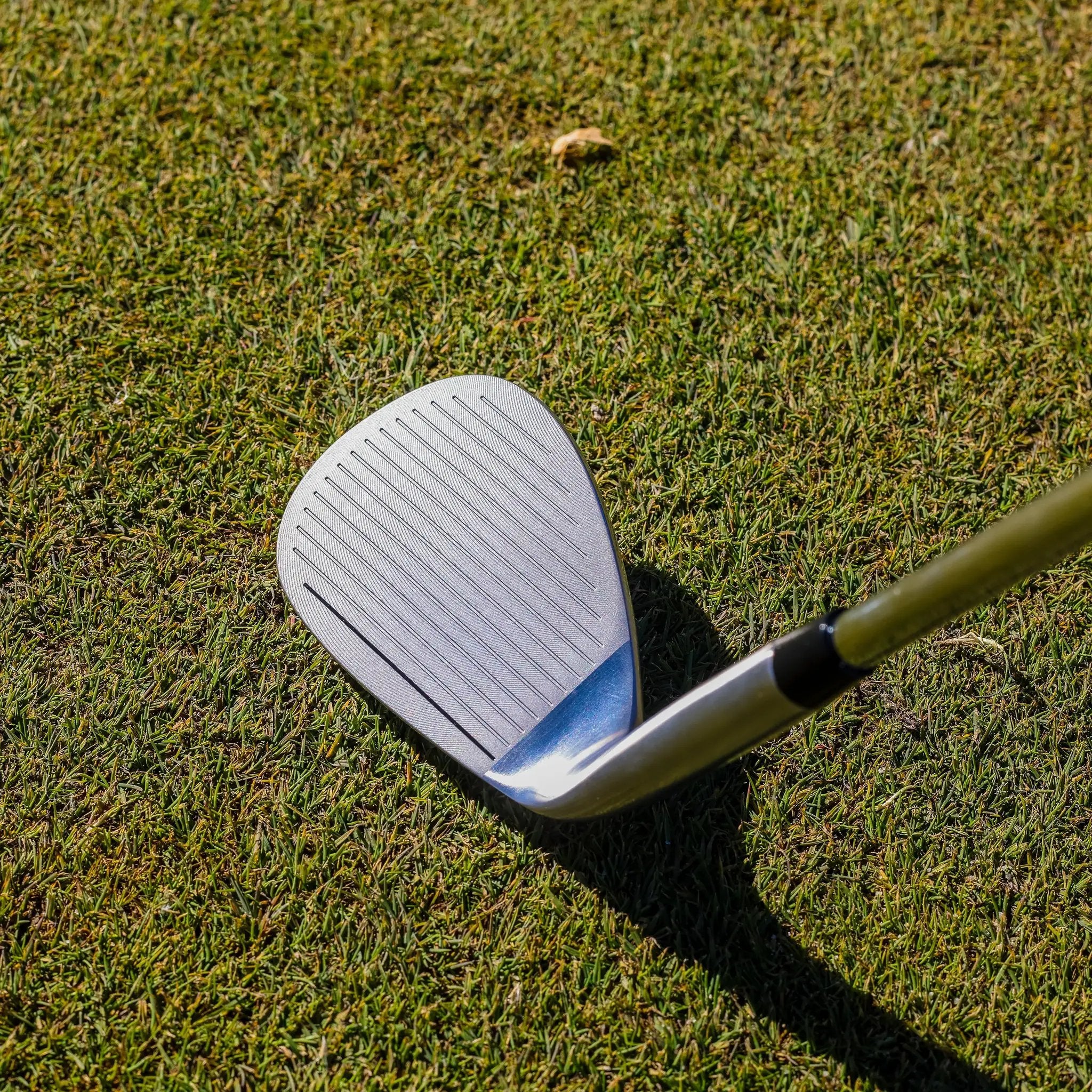 Ase Golf 3-Piece Wedge Set with two silver wedges on grass.