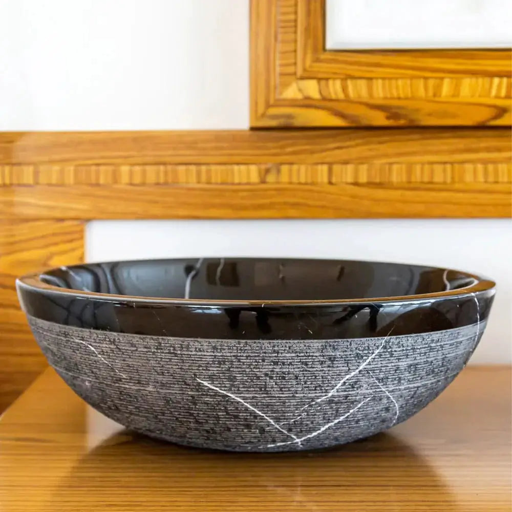 Toros Black natural stone bathroom sink, round above-counter bowl with black interior and gray-veined exterior.