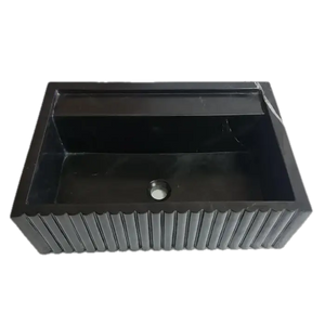 Toros black marble rectangular wall-mount sink with fluted exterior and interior basin with drain hole.