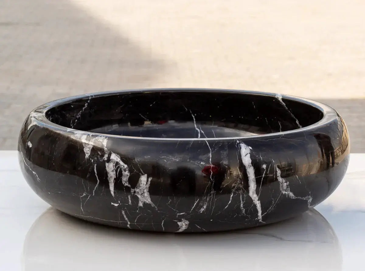 Toros Black Marble vessel sink by Villohome, black stone with white veining, 16 in diameter.