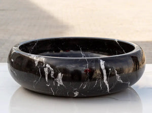Toros Black Marble vessel sink by Villohome, black stone with white veining, 16 in diameter.