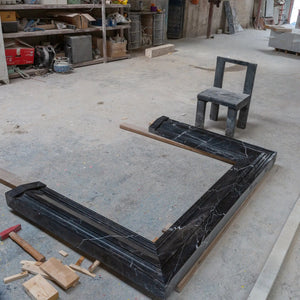 Toros Black Marble fireplace mantel by Villohome, polished hand-carved black marble in workshop setting