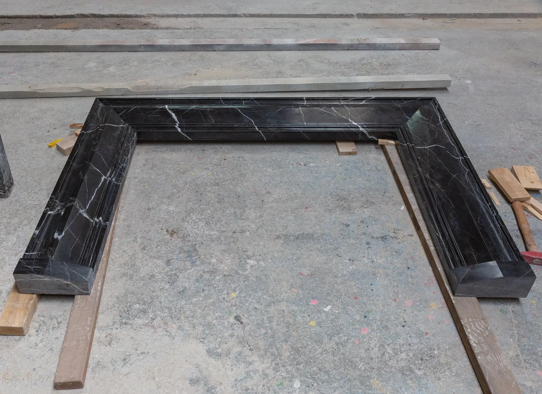 Toros Black Marble fireplace mantel, hand-carved and polished with white veining.